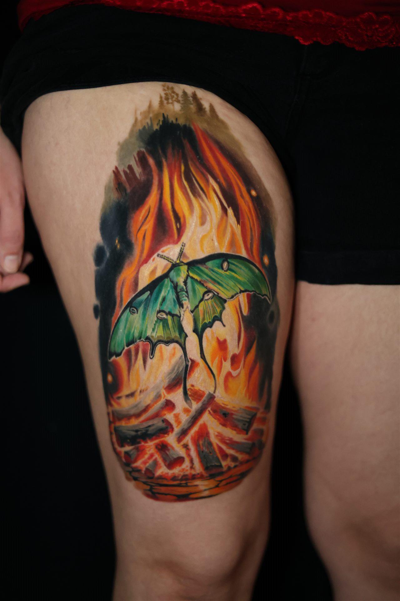 Moth in flames illustrative color tattoo — thigh